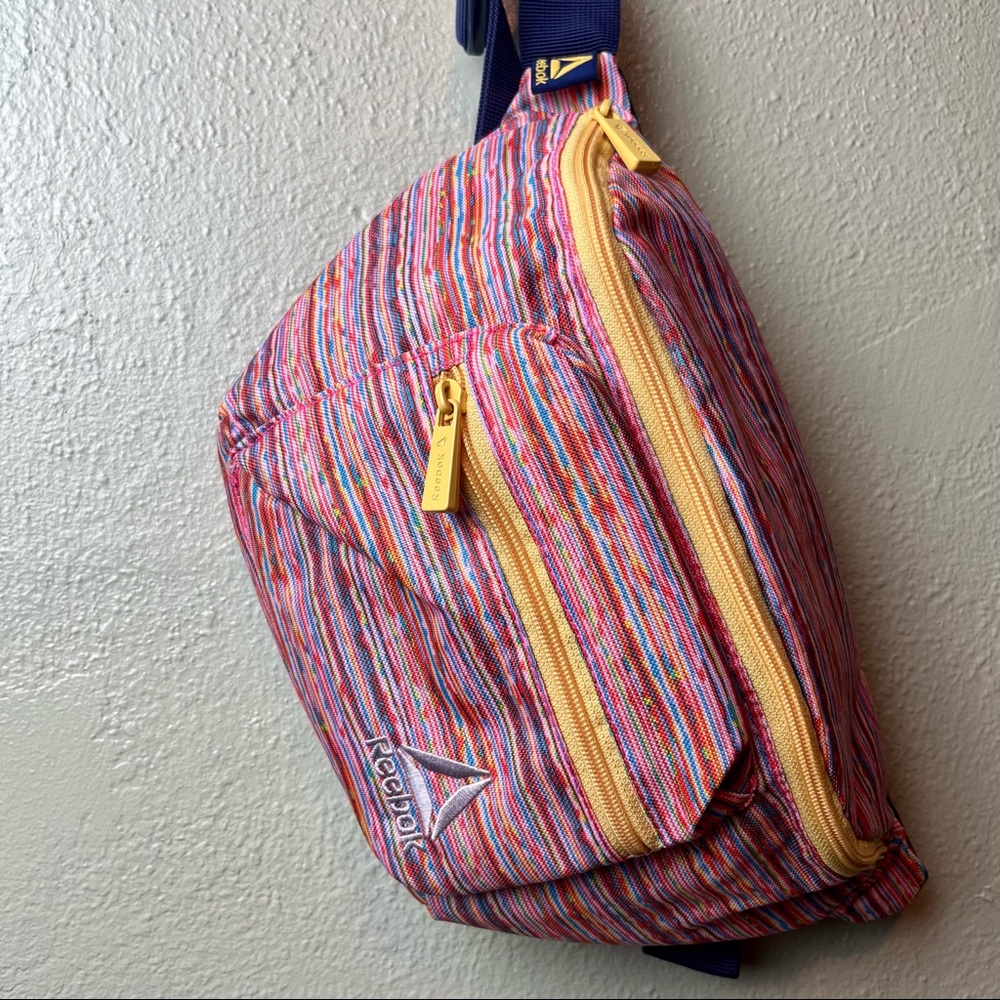 REBOOK vibrant striped belt bag with blue strap